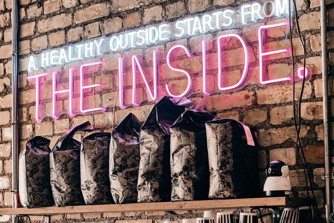 Neon sign and decorative cushions at Music & Beans Haringey, London