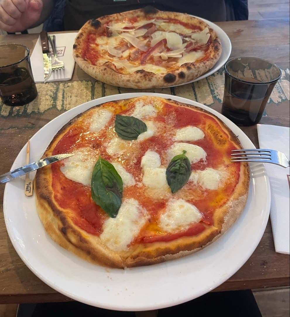 Margherita and prosciutto pizzas at Terra Rossa, London