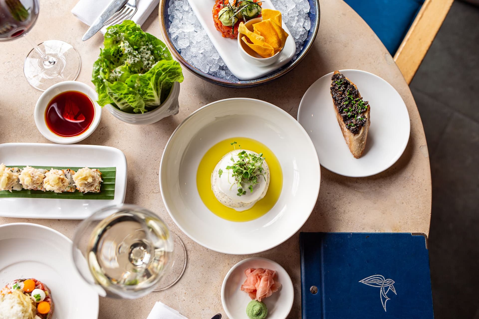 Shared dining table spread at Bluebird Chelsea, London