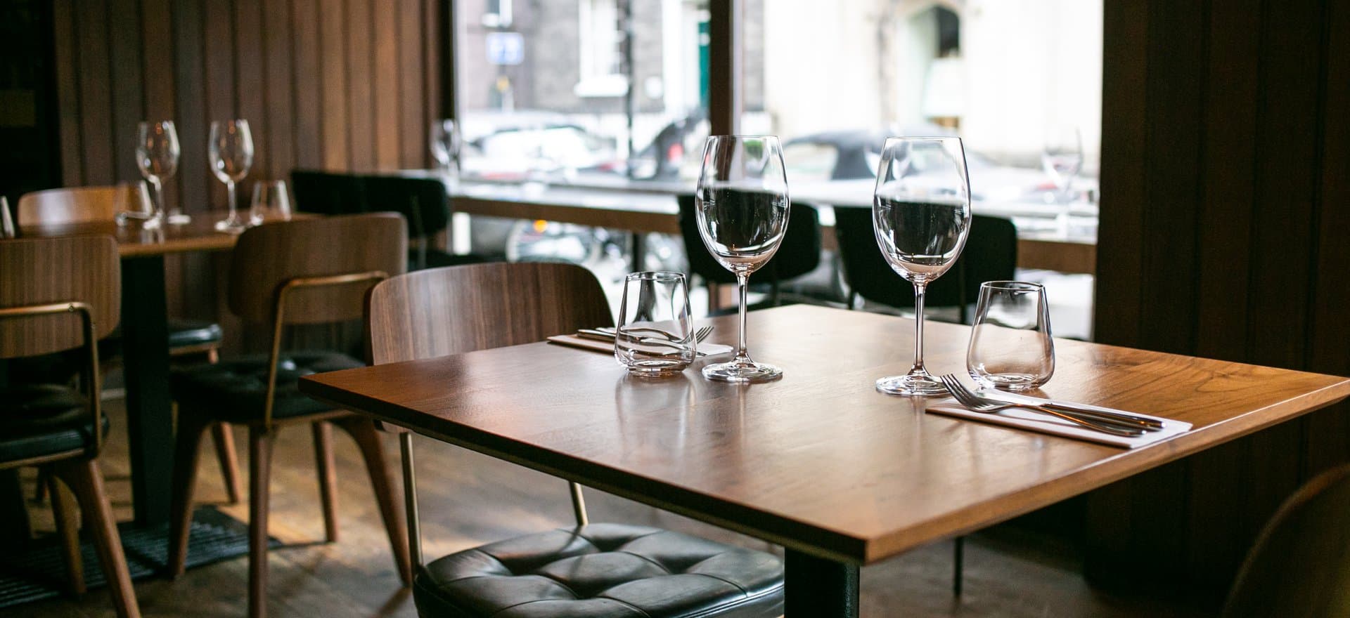 Table setting with wine glasses at Pizarro, London