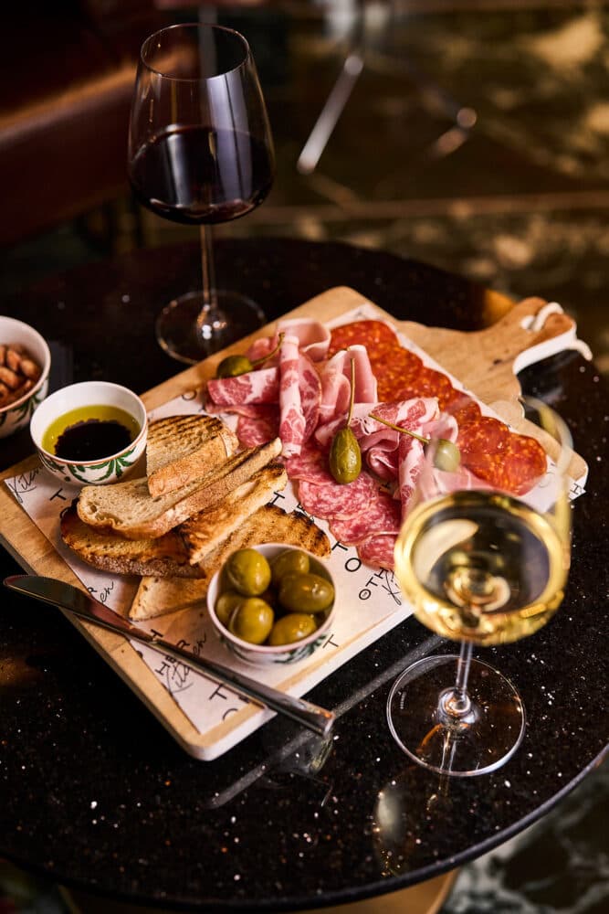 Charcuterie board with wine at The Owl and Monkey, London