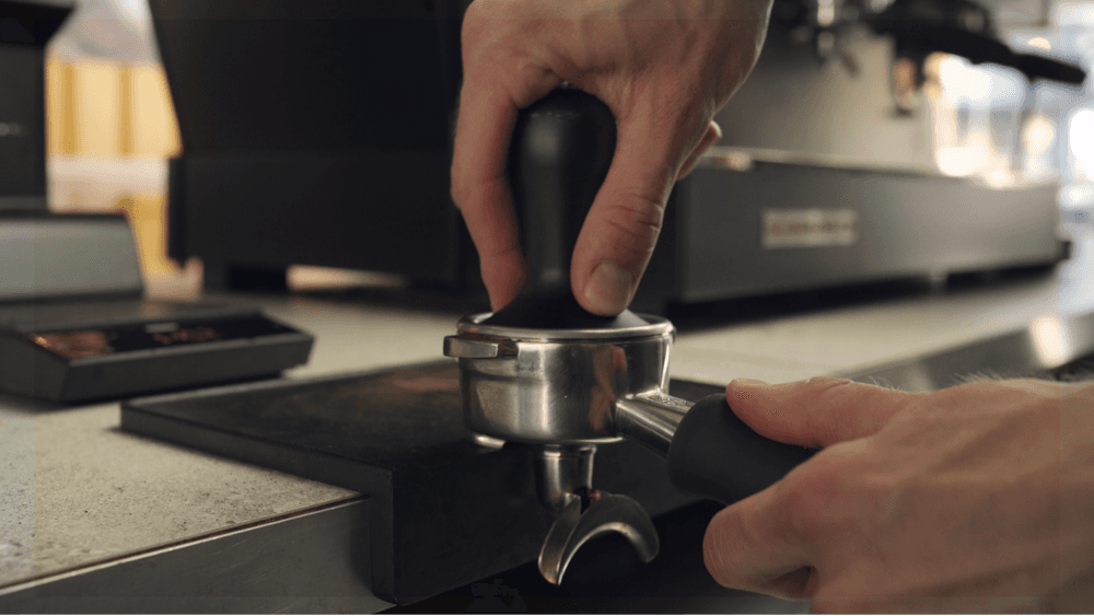 Barista coffee tamping at Sendero Specialty Coffee Brixton, London