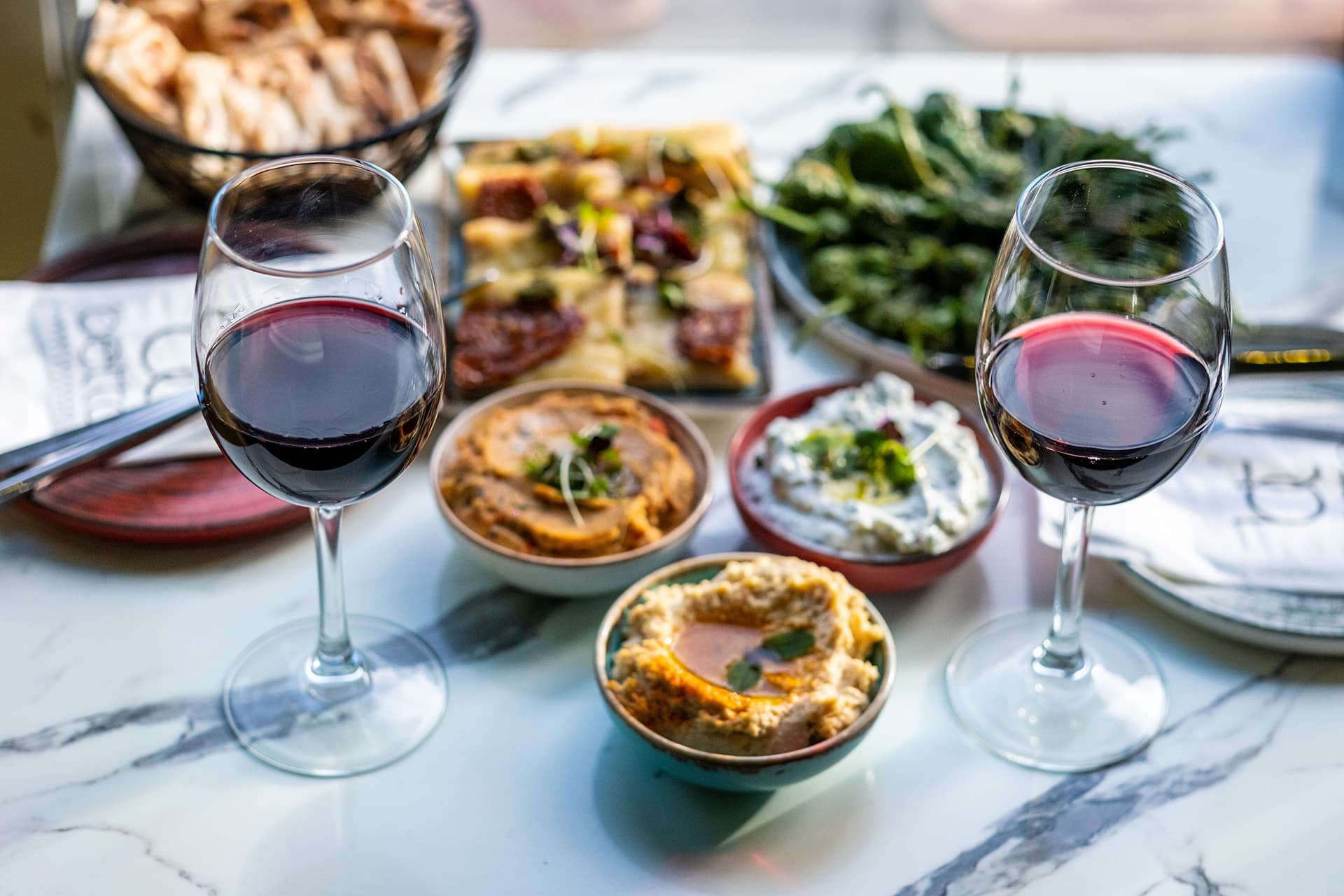 Tapas sharing spread with wine at Betto Tapas Restaurant & Cocktail Bar, London