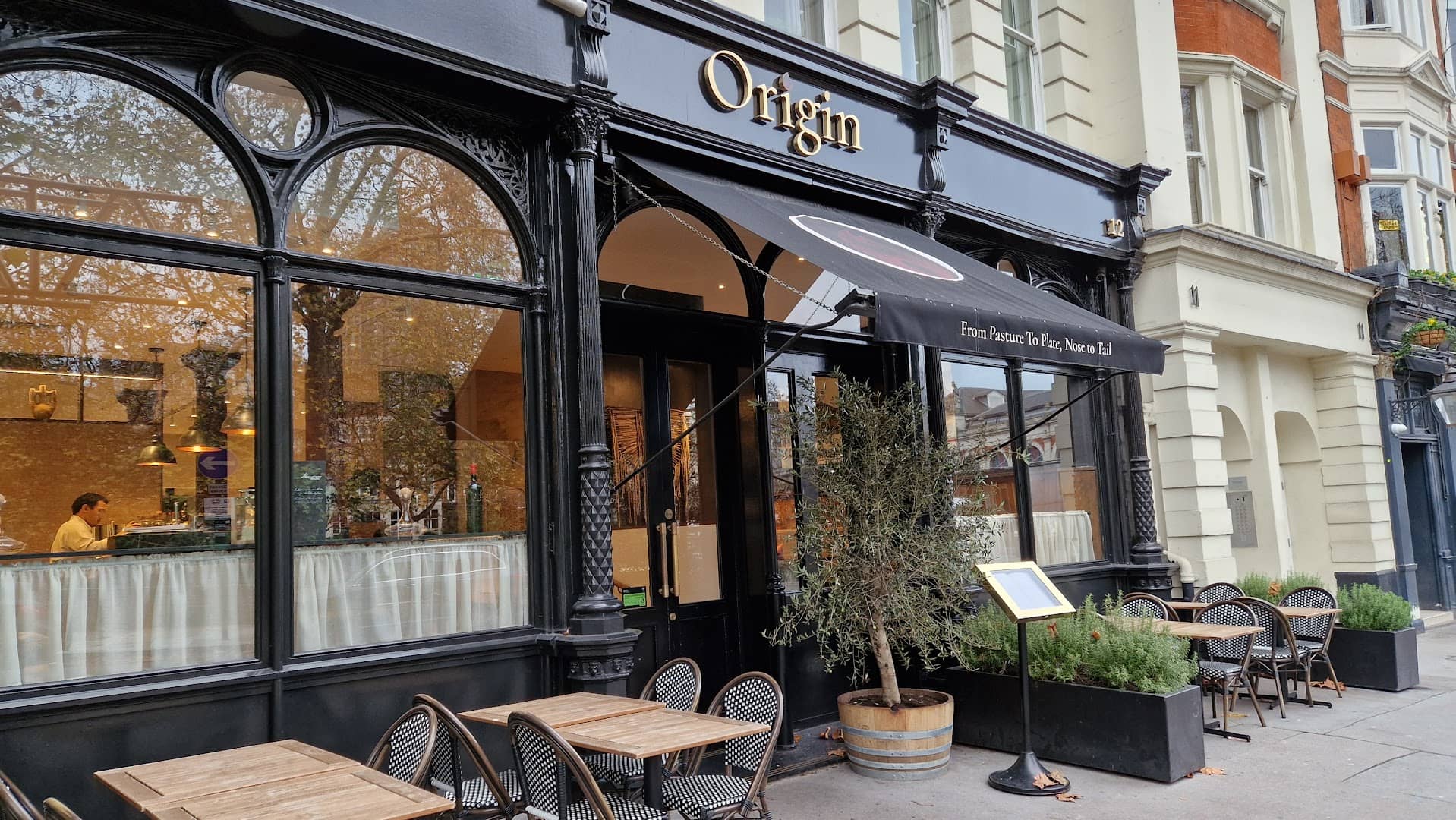 Front facade with outdoor seating at Origin City, London