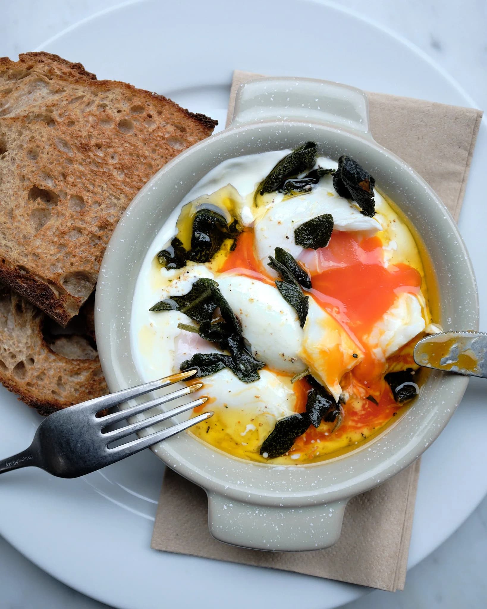 Baked eggs with sage and sourdough toast at Potter & Reid, London