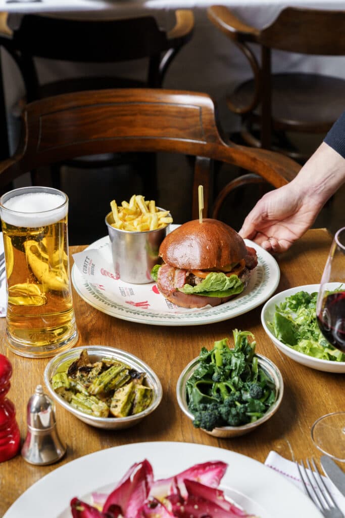 Burger and sides table spread at The Thomas Cubitt Pub, Belgravia, London
