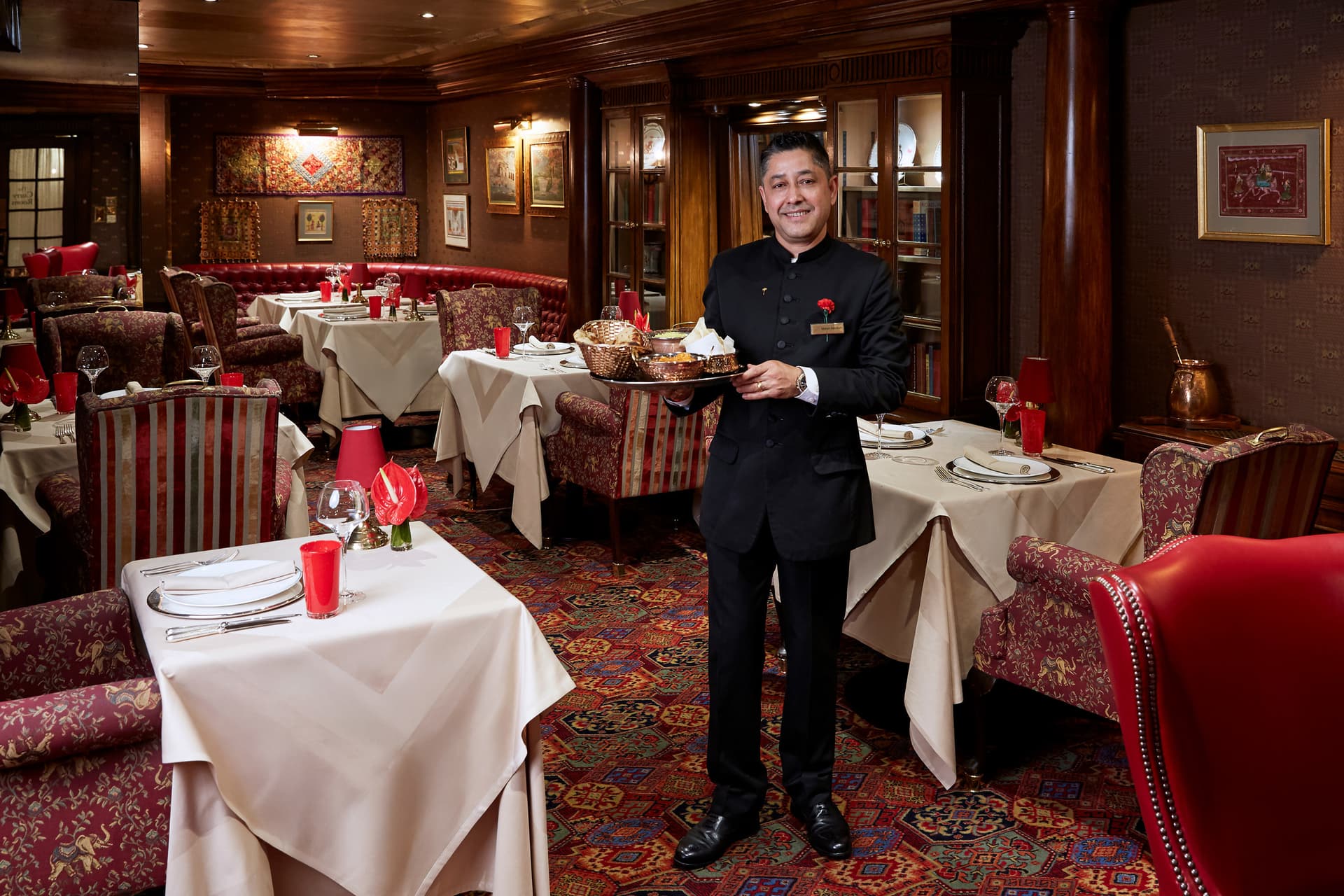 Elegant fine dining room with server at The Curry Room, London