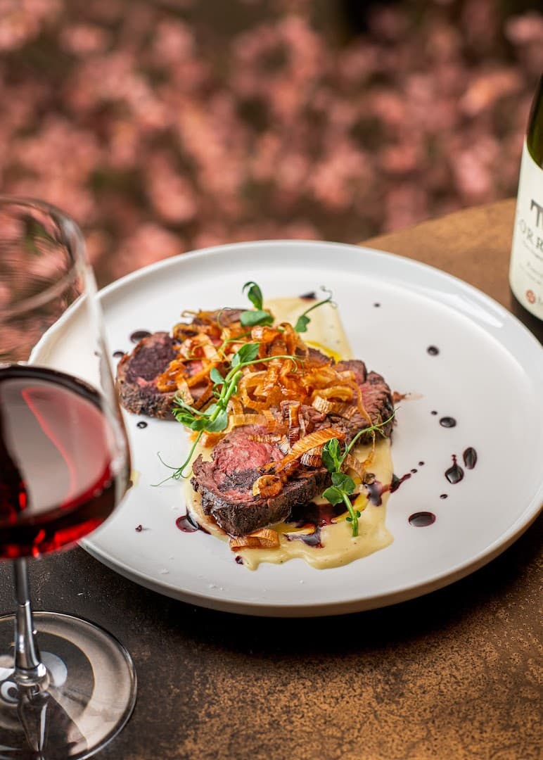 Steak dish with red wine at Wolfox Savoy London, London