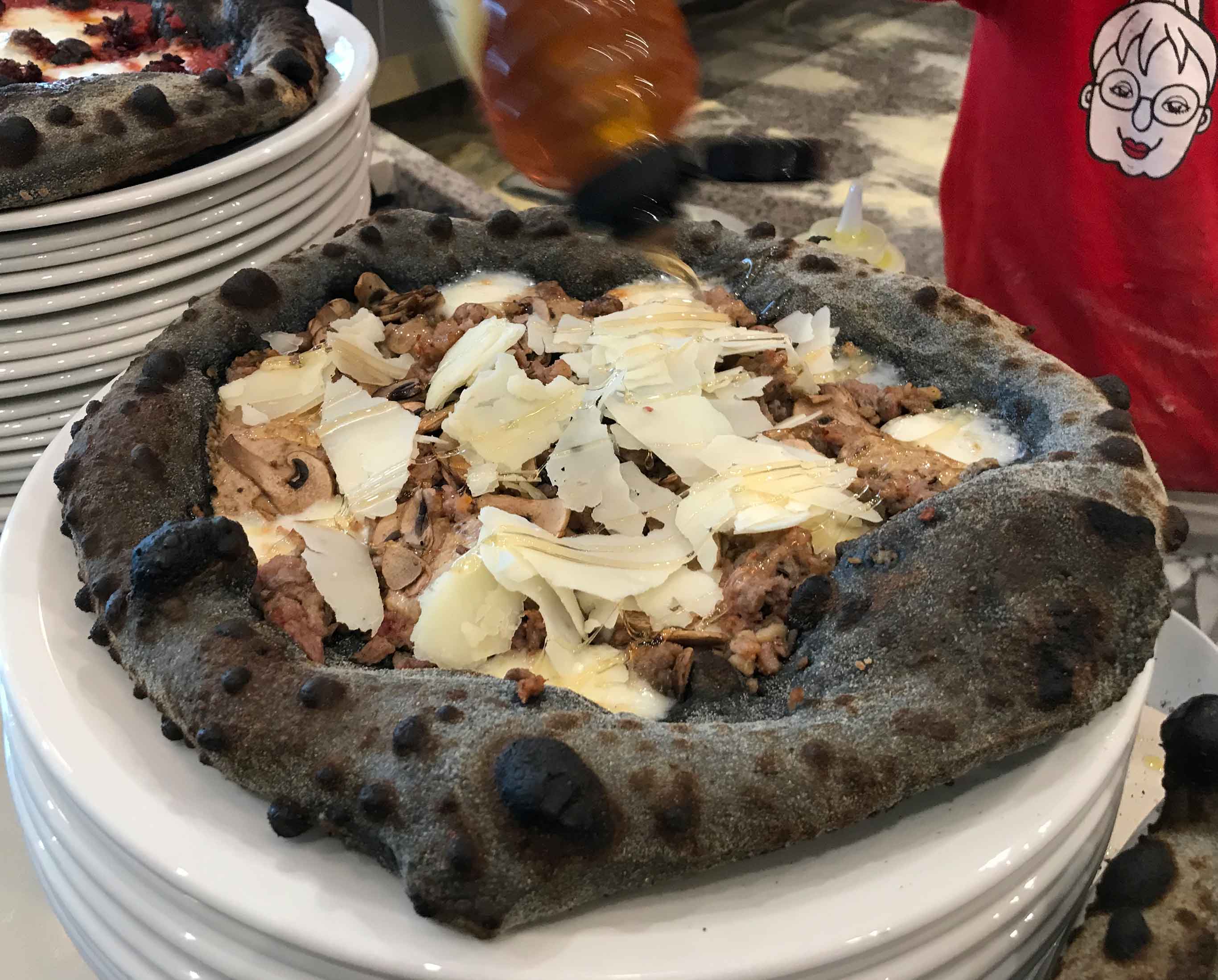 Charcoal pizza with sausage and parmesan at Zia Lucia, West Hampstead, London