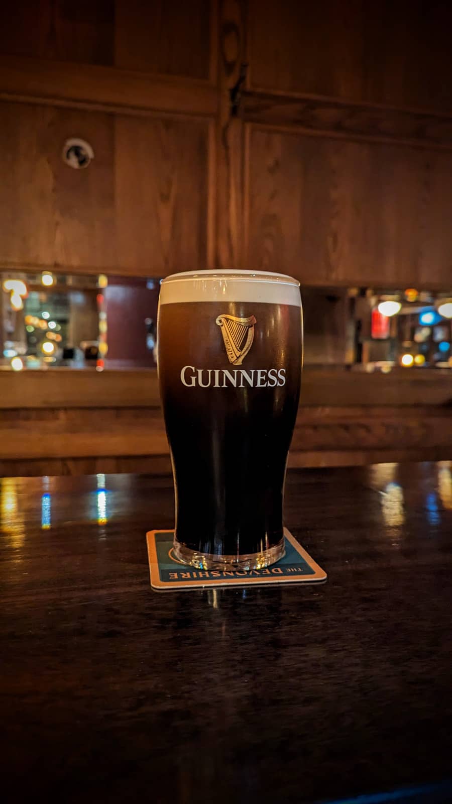 Guinness pint at bar at The Devonshire, London