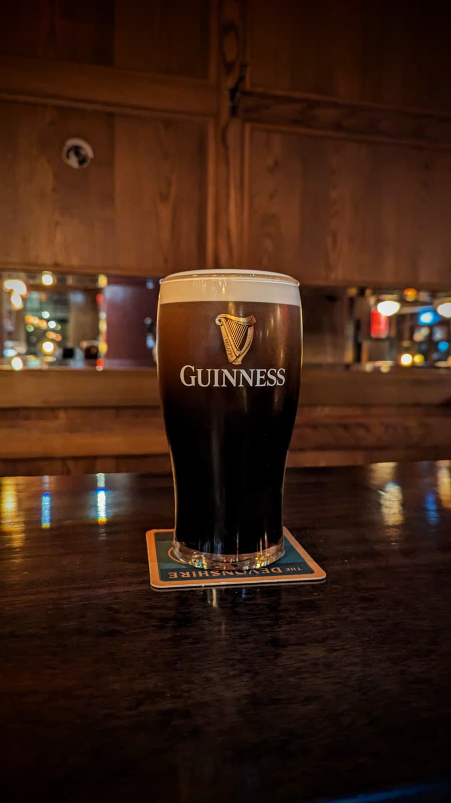 Guinness pint at bar at The Devonshire, London