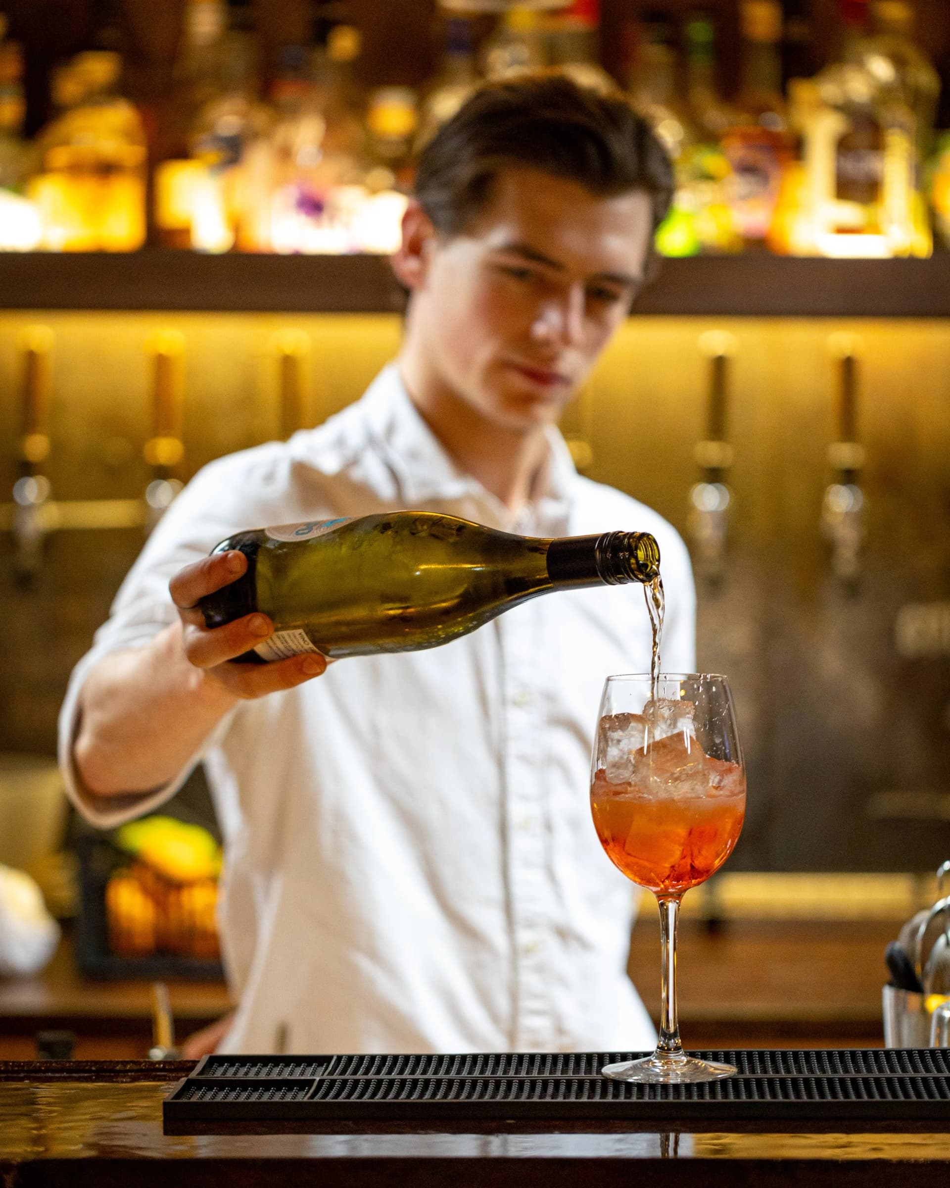 Bartender pouring cocktail at Barge East, London