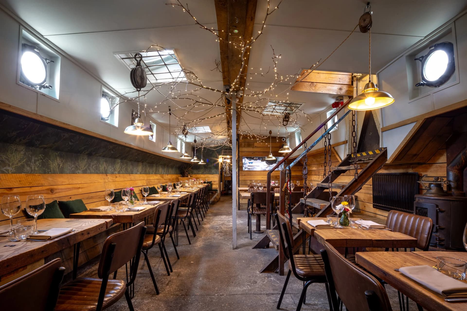 Rustic barge interior dining room at Barge East, London