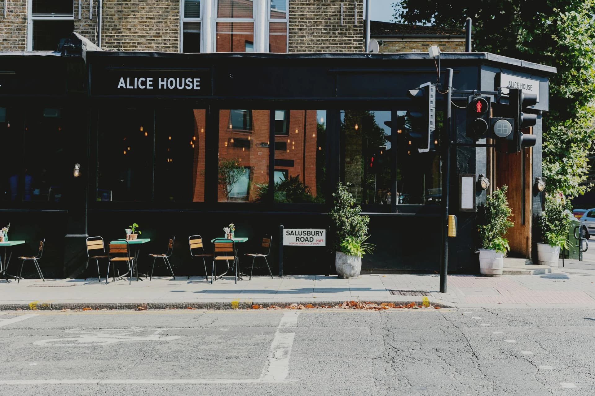 Front facade with outdoor seating at Alice House, Queen's Park, London