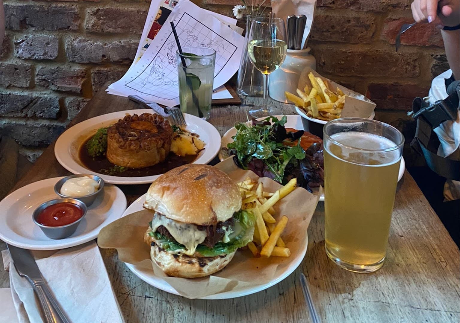 Pub food spread with burger and pie at Alice House Queen's Park, London