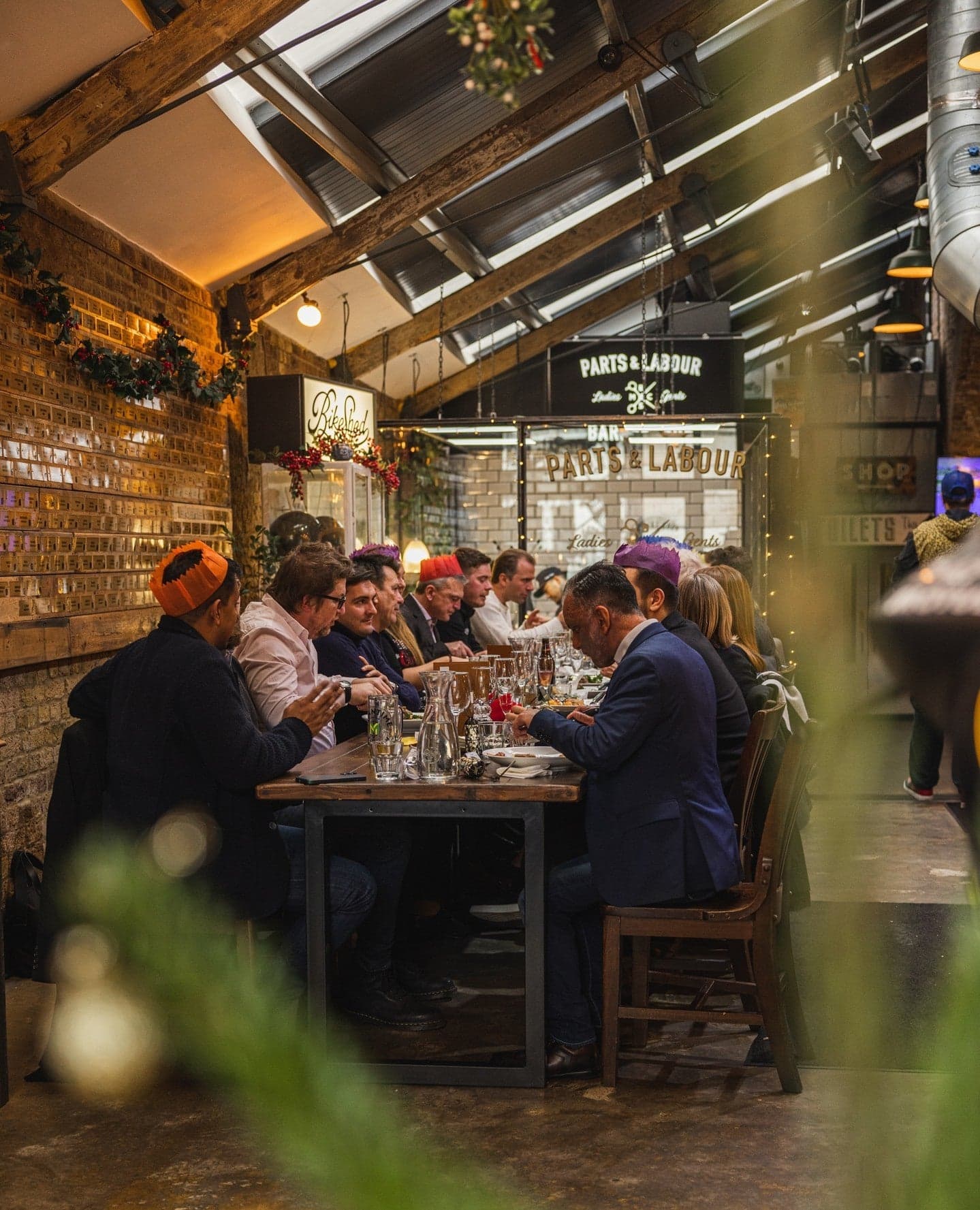 Industrial dining area with long communal table at Bike Shed Moto Co., London