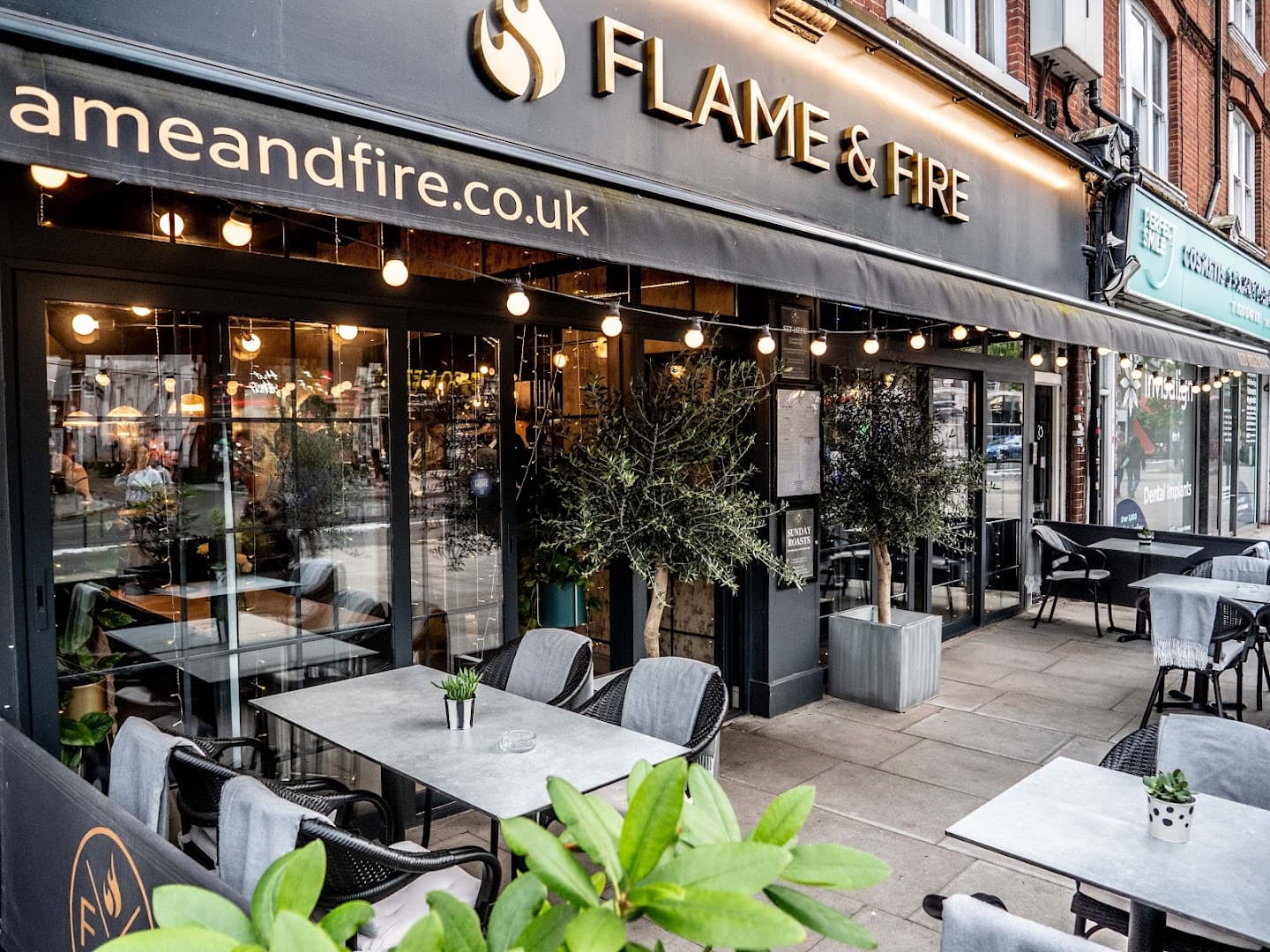 Front facade with outdoor seating at Flame & Fire, London