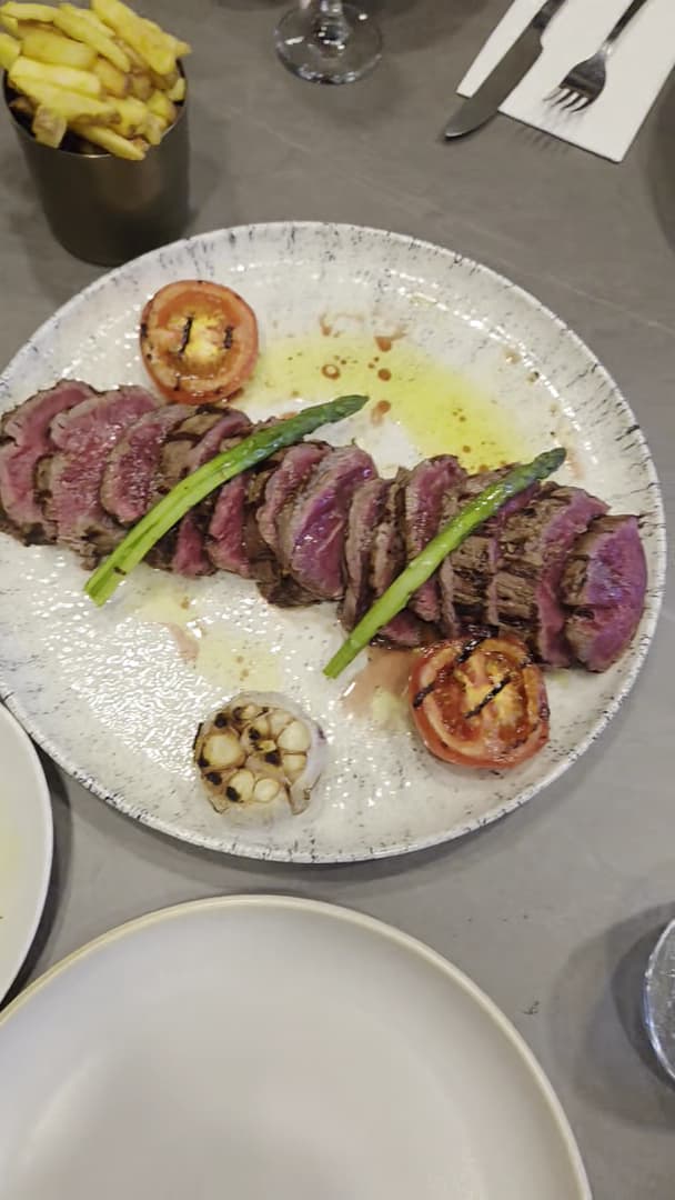 Sliced steak with asparagus and roasted vegetables at Flame & Fire, London