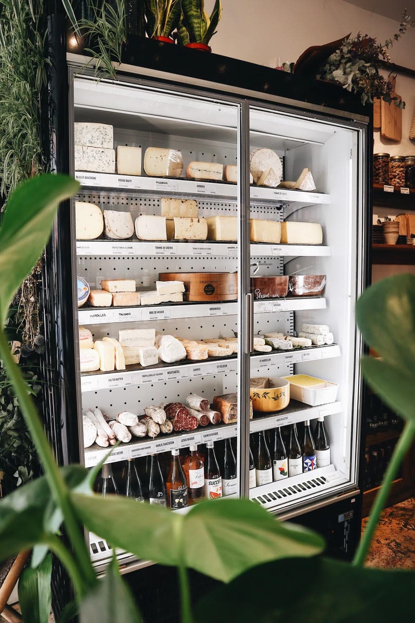 Artisan cheese display fridge at Bermondsey Corner, London