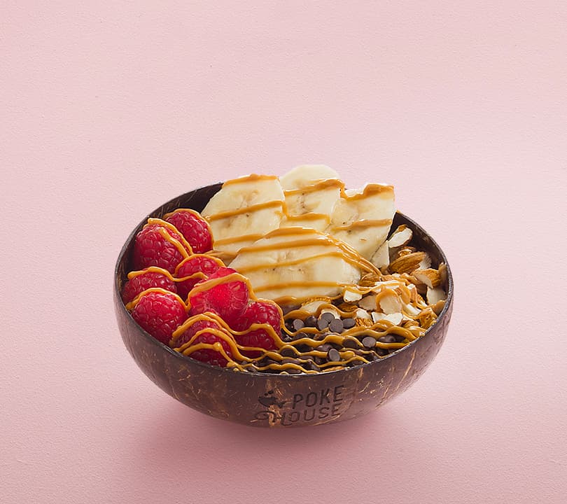Açai bowl with banana, raspberries and toppings at Poke House, Battersea Power Station, London