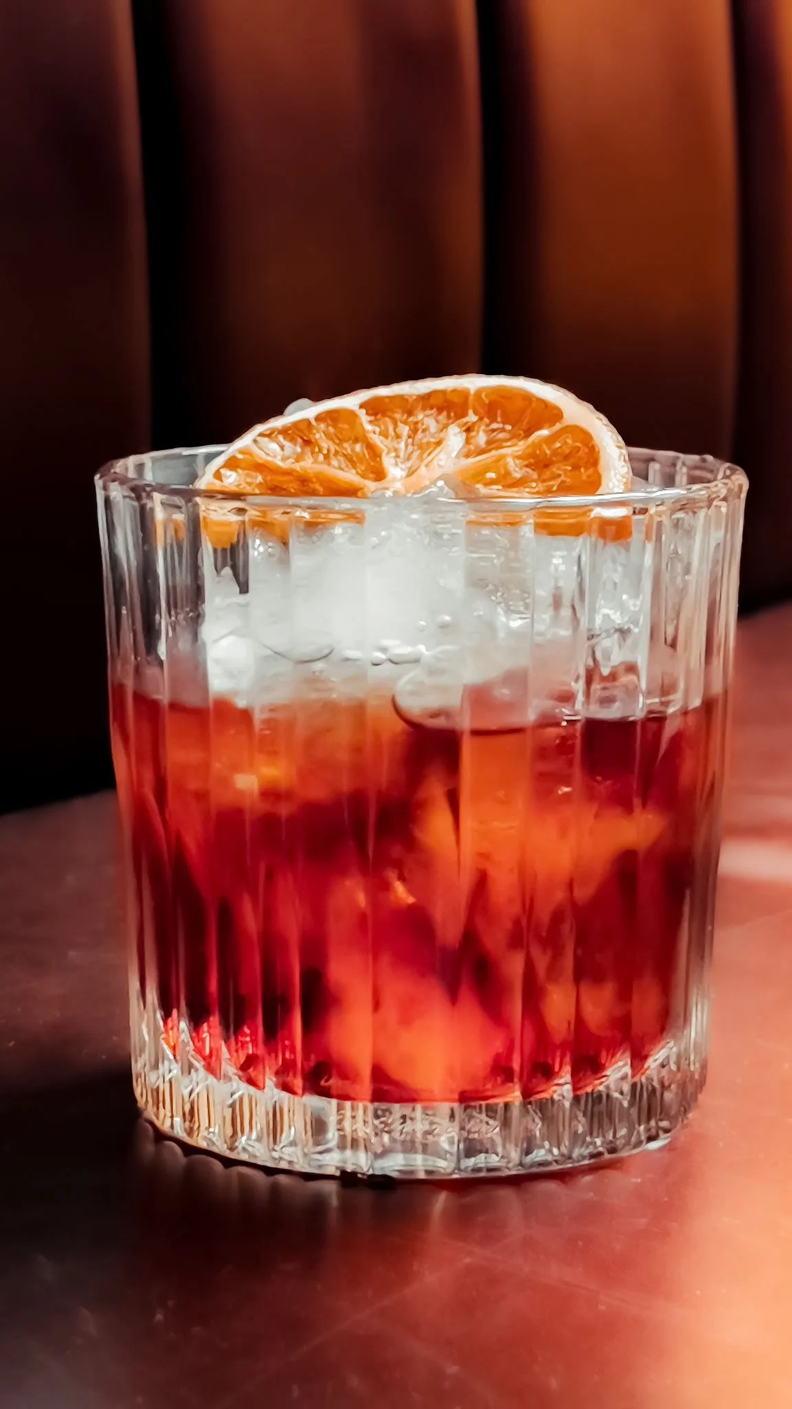 Cocktail with citrus garnish at The Talbot, London