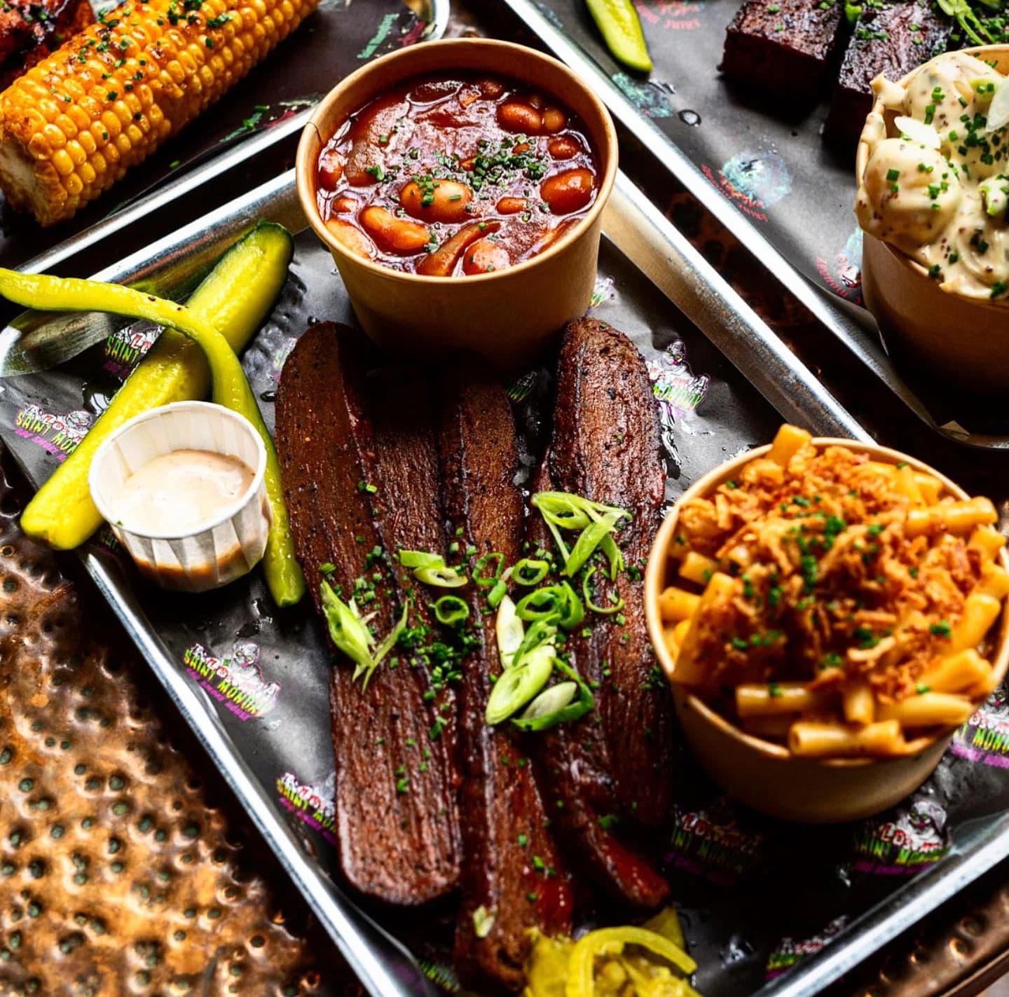 BBQ platter with brisket, ribs and sides at Saint Monday, London