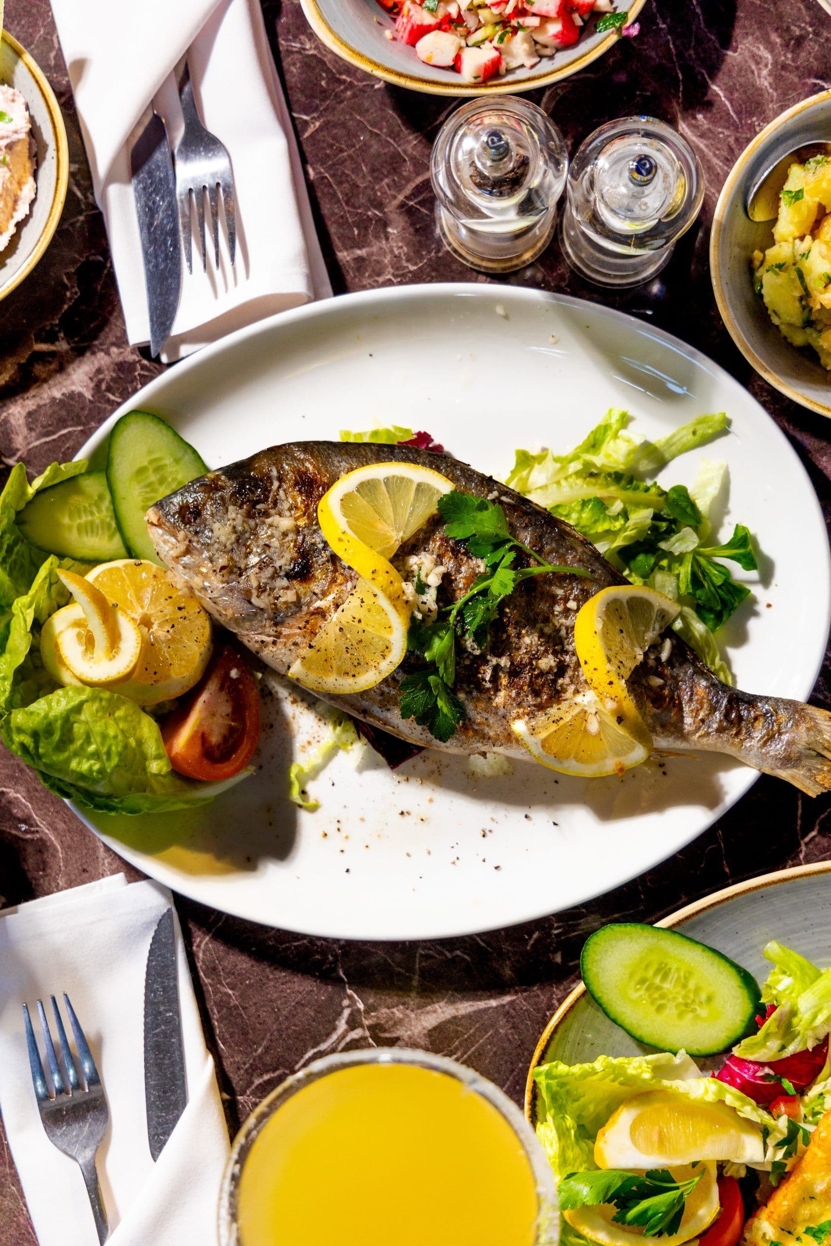 Whole grilled fish with lemon at Andromeda Greek Restaurant, London