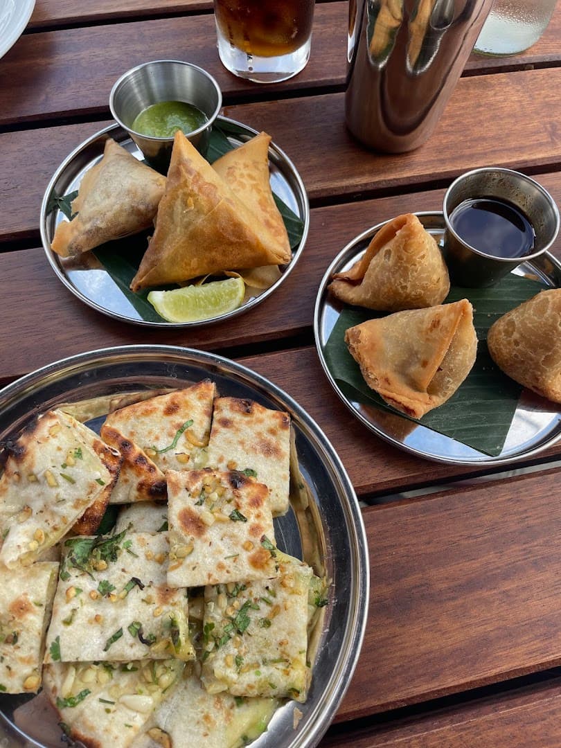 Samosas and naan dishes at Dishoom Permit Room Portobello, London