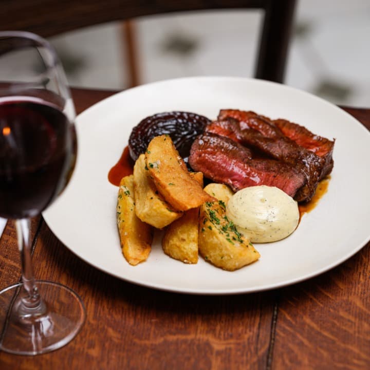 Sirloin steak with roast potatoes at The Hunter's Moon, London