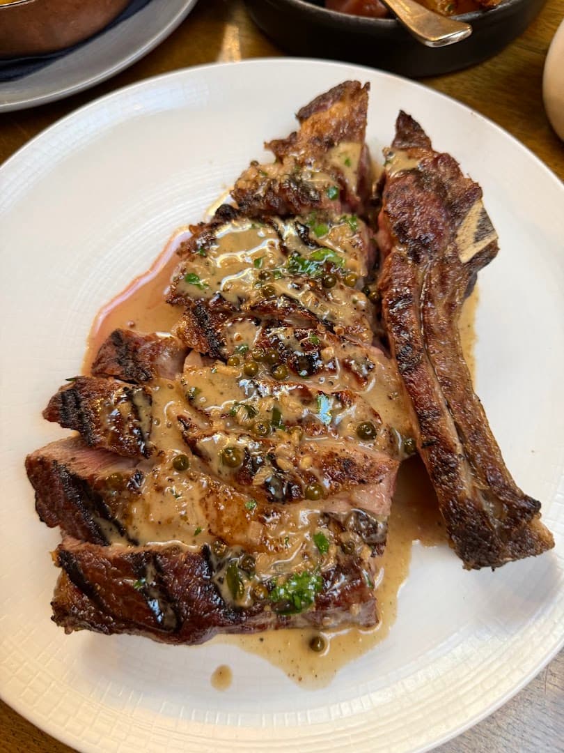 Sliced steak with peppercorn sauce at The Hunter's Moon, London