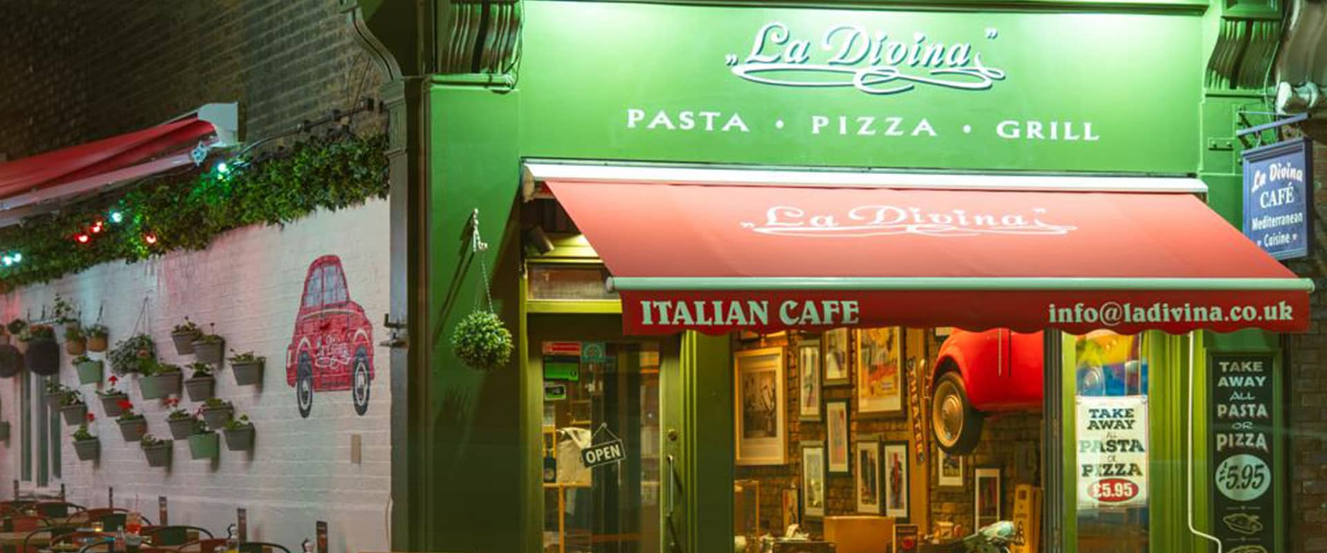 Front facade at night at La Divina Italian Restaurant, London