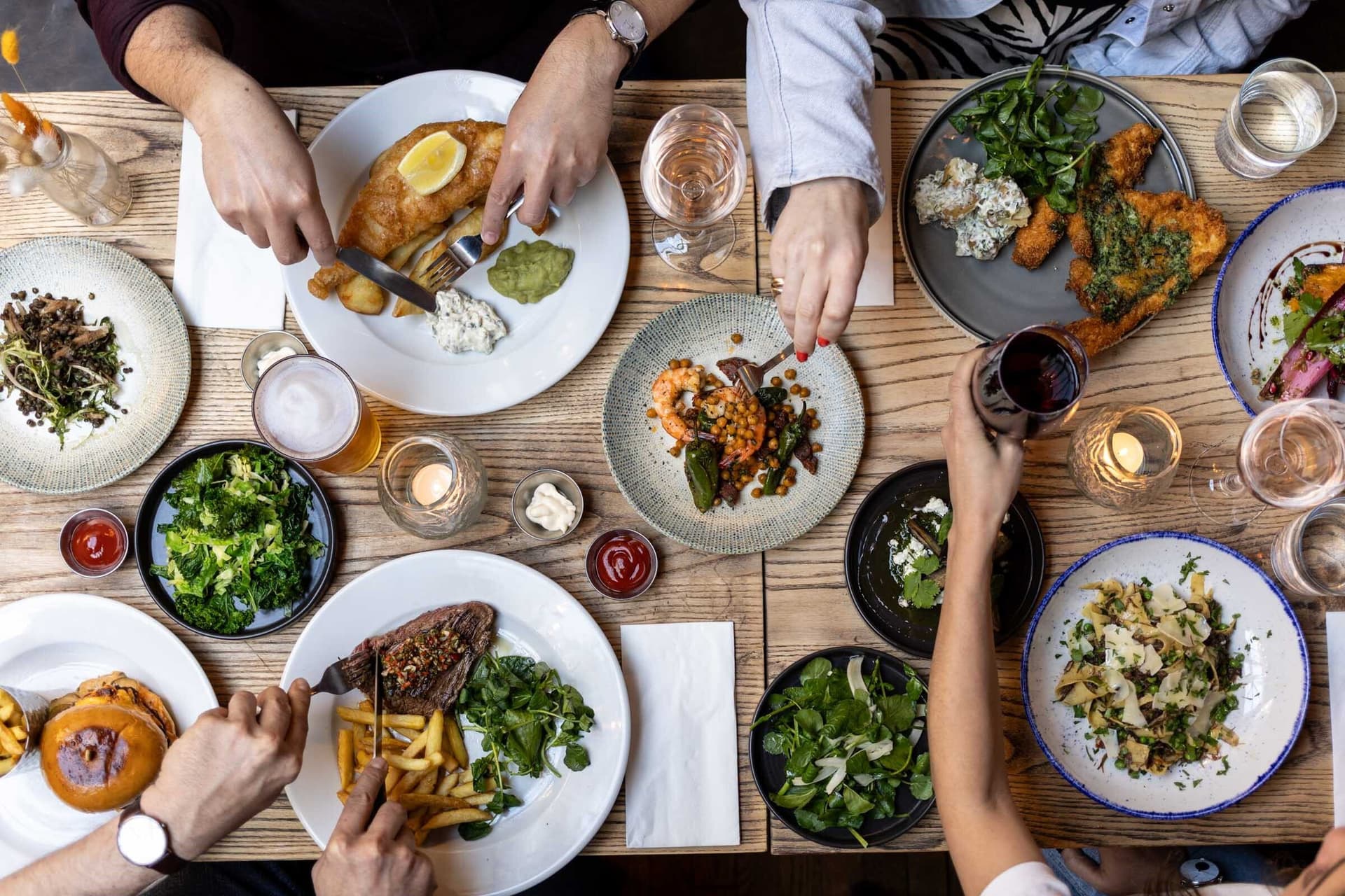 Shared dining table spread at The Horseshoe, Hampstead, London