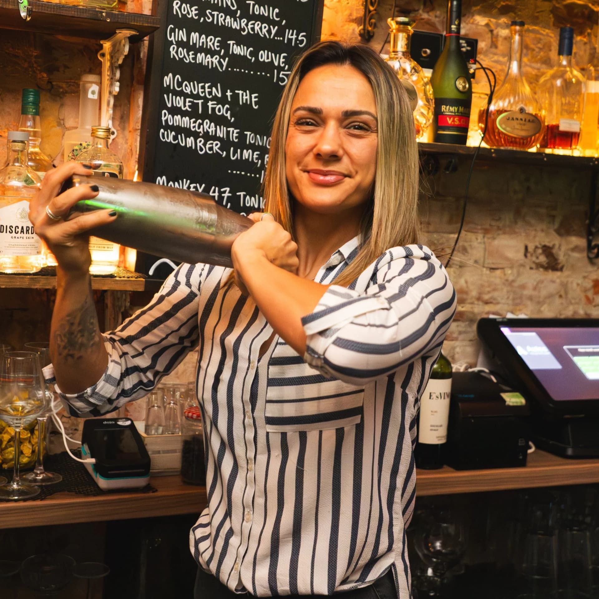 Bartender preparing cocktails at The Little Blue Door, London
