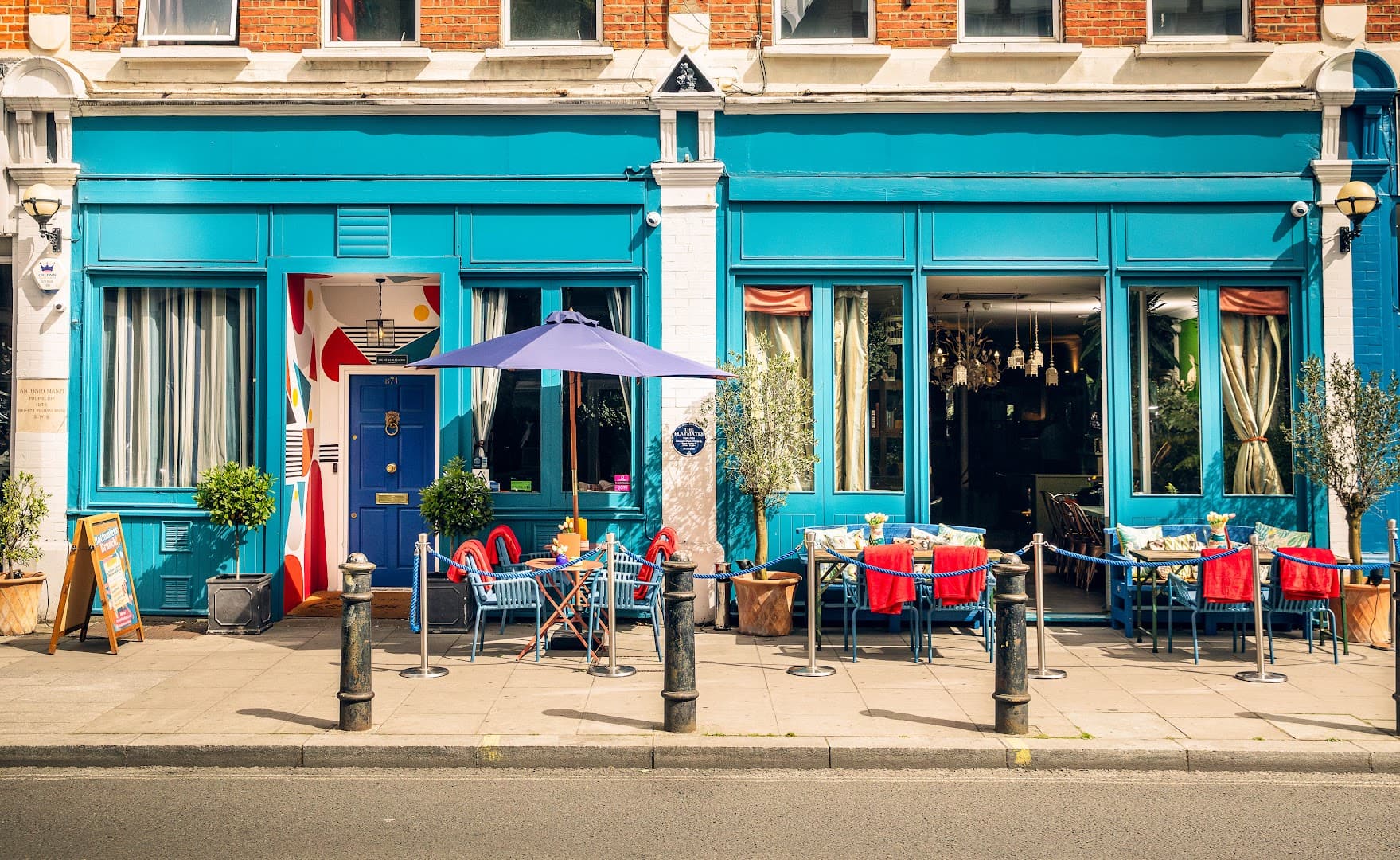Front facade with outdoor seating at The Little Blue Door, London