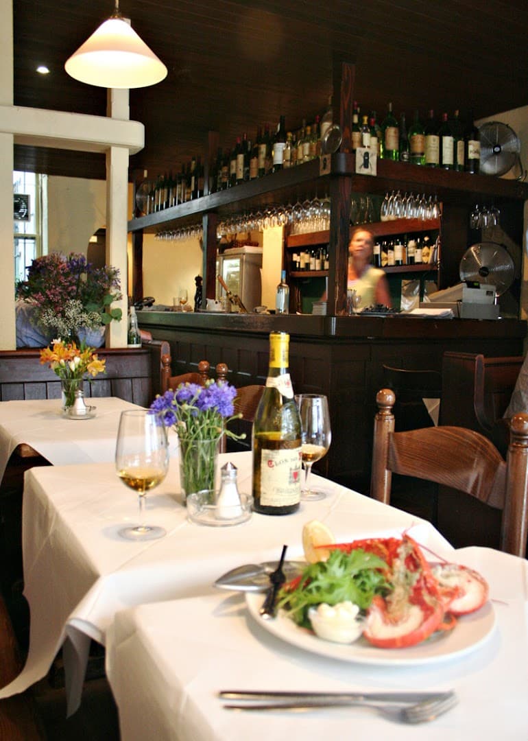 Intimate table setting with wine and lobster at Andrew Edmunds, London