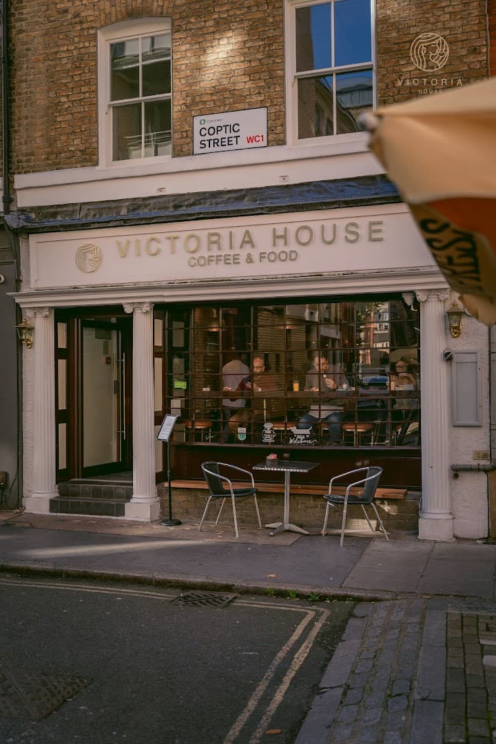 Front facade with outdoor seating at Victoria House Coffee & Food, Coptic Street, London