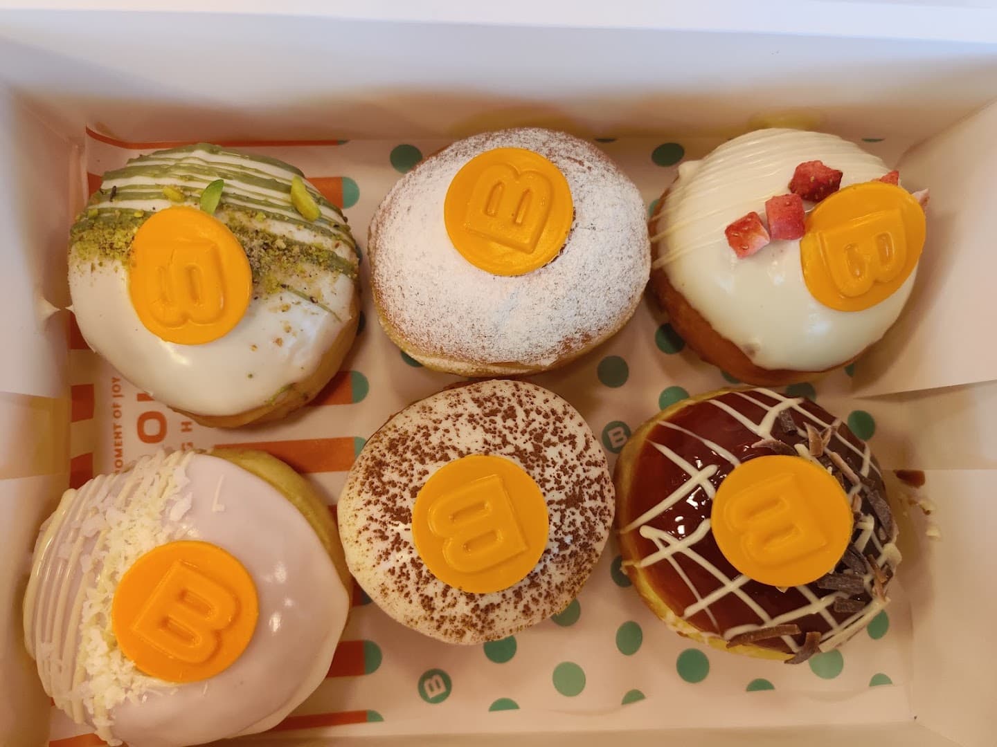 Assorted gourmet doughnuts at Bombolone Doughnuts, London