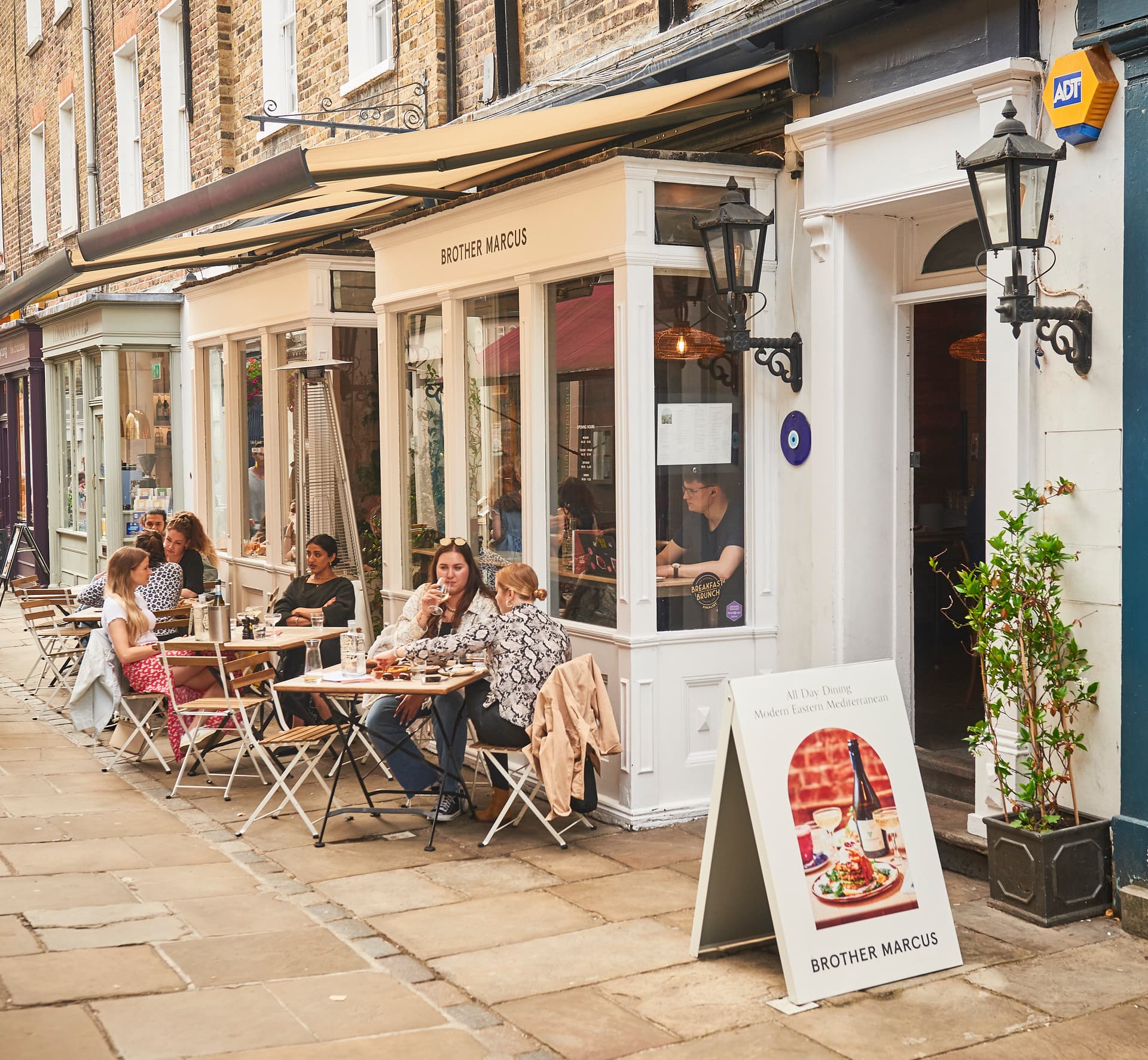 Front facade with outdoor seating at Brother Marcus Angel, London
