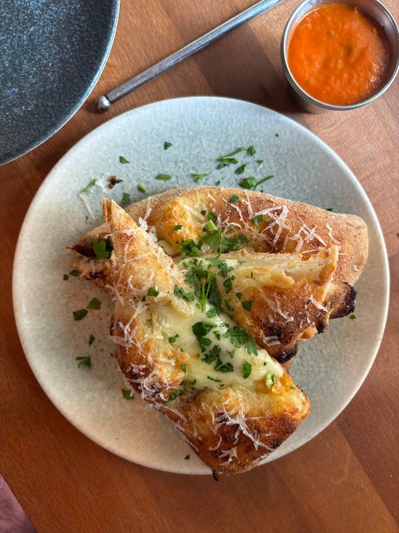 Garlic bread with sauce at Alley Cats Pizza, London