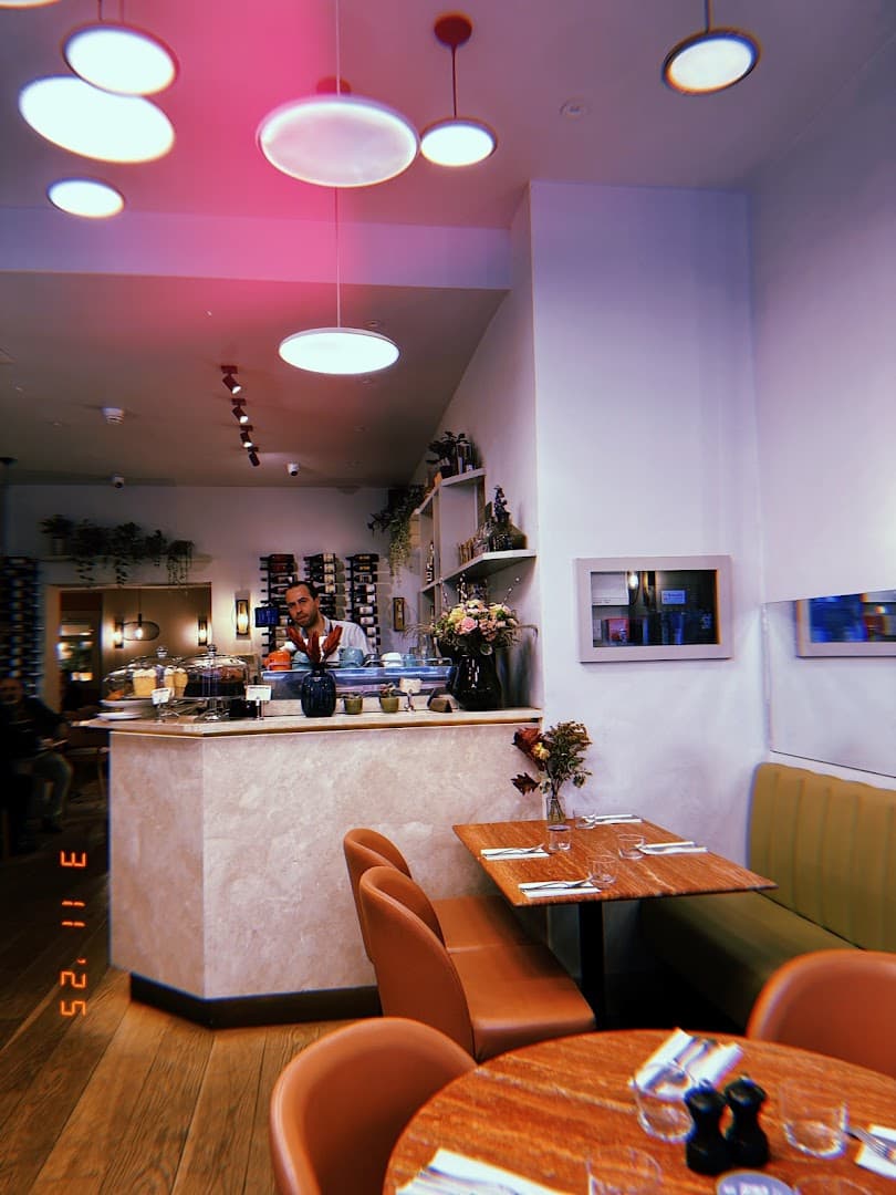 Modern dining room with pink lighting at England's Grace, London