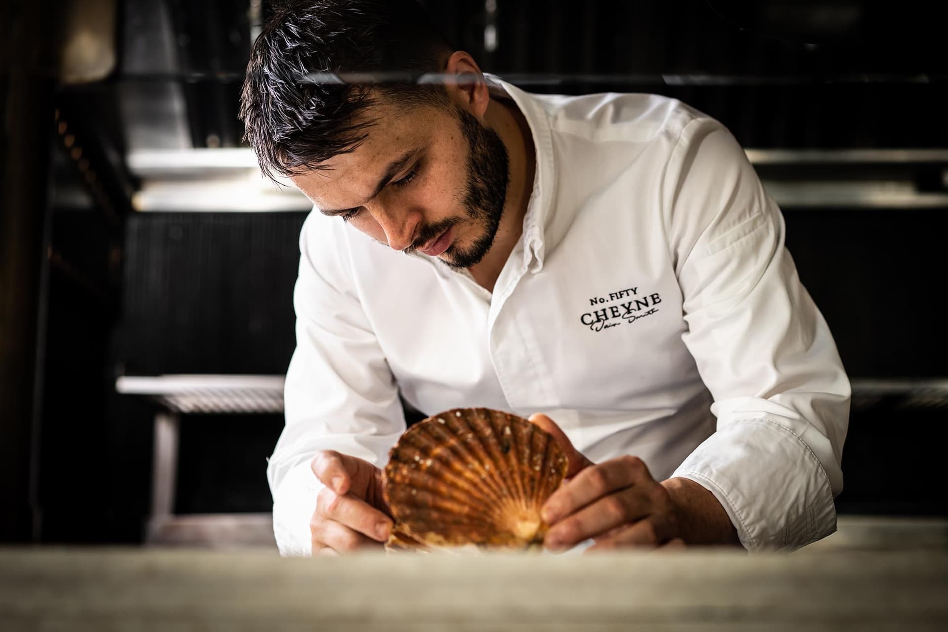Chef preparing scallop at No. Fifty Cheyne, London