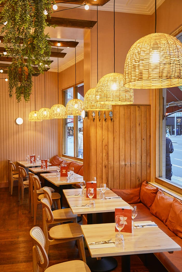 Stylish dining room with woven wicker pendant lights at Brother Marcus South Kensington, London