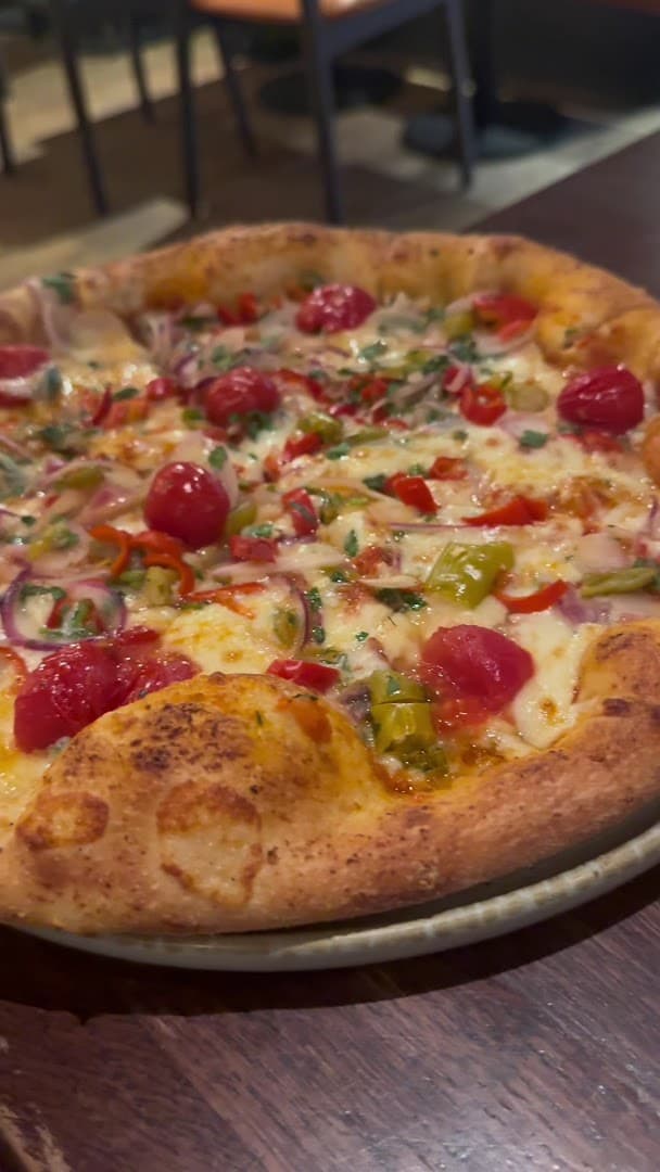 Pizza with cherry tomatoes and peppers at Gallio, London