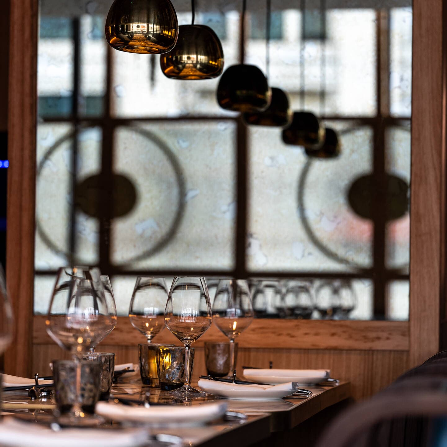 Elegant table setting with modern pendant lighting at Gouqi, London