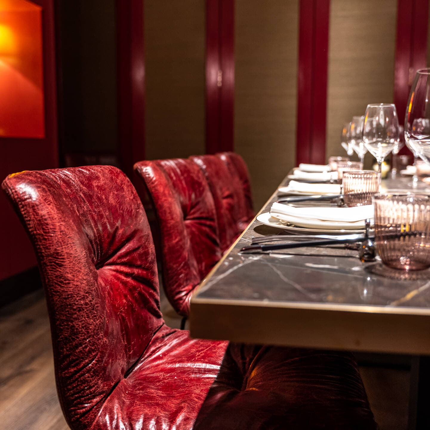 Luxurious table setting with red velvet chairs at Gouqi, London