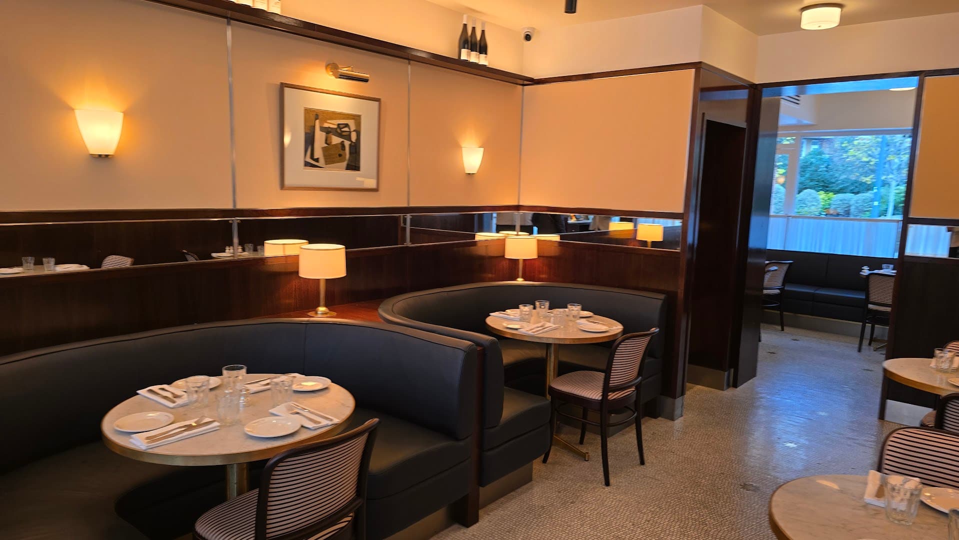 Curved banquette seating area at Le Café NAC, London