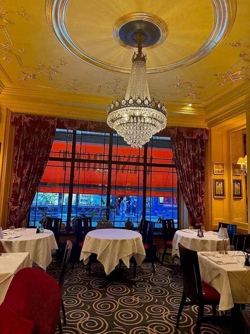 Elegant dining room with crystal chandelier at L'Escargot Restaurant, London