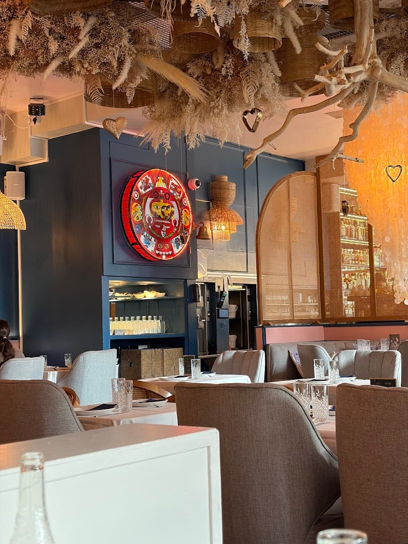 Dining room with decorative ceiling and Mexican art at Mestizo Chelsea, London