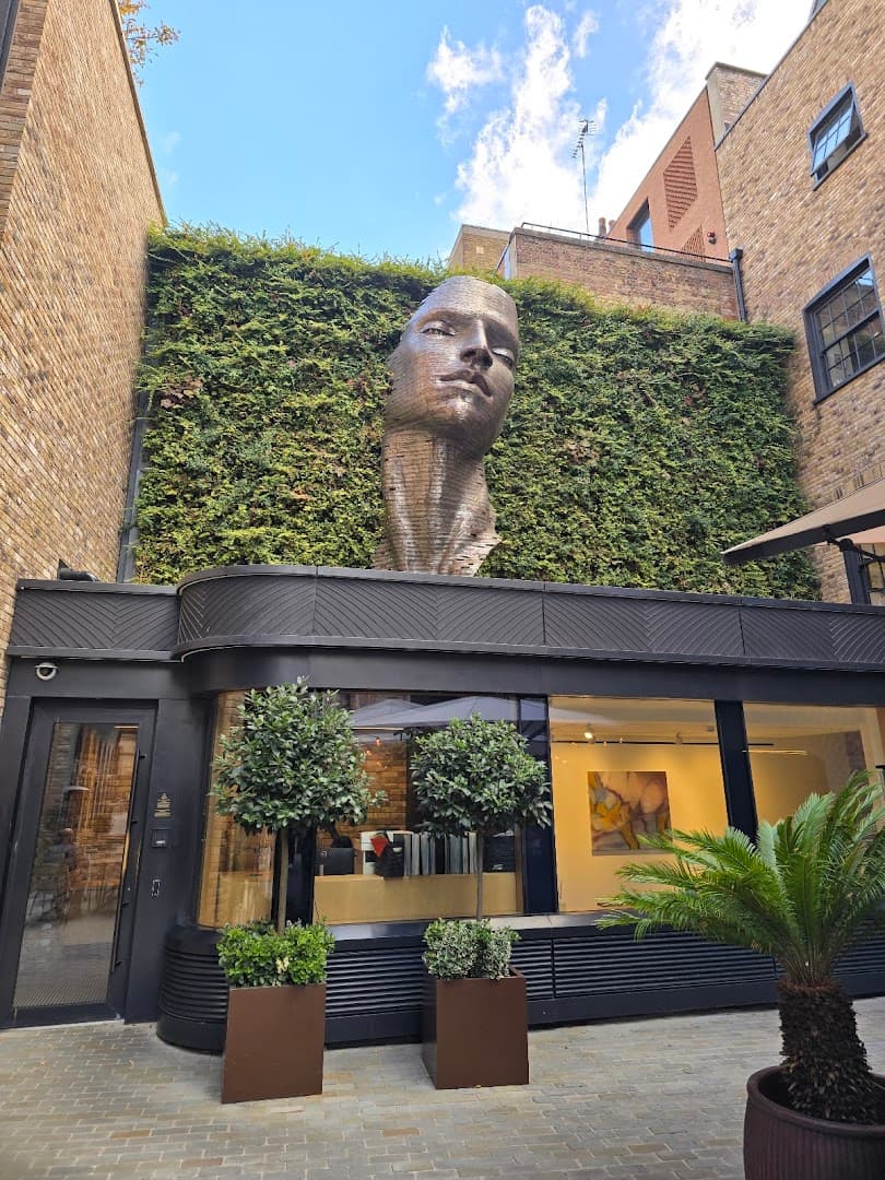 Courtyard entrance with striking sculpture at Milk Beach Soho, London