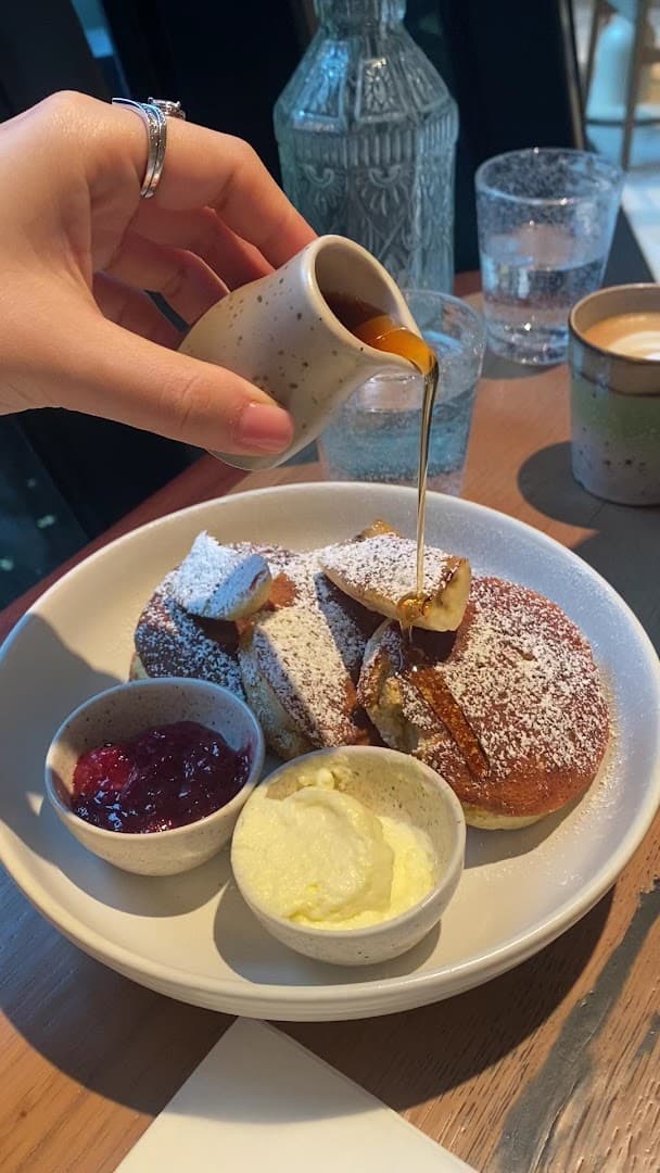 Fluffy pancakes with syrup at Milk Beach Soho, London